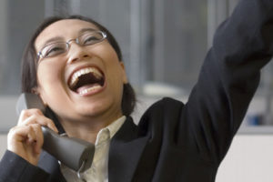 Woman on phone celebrating