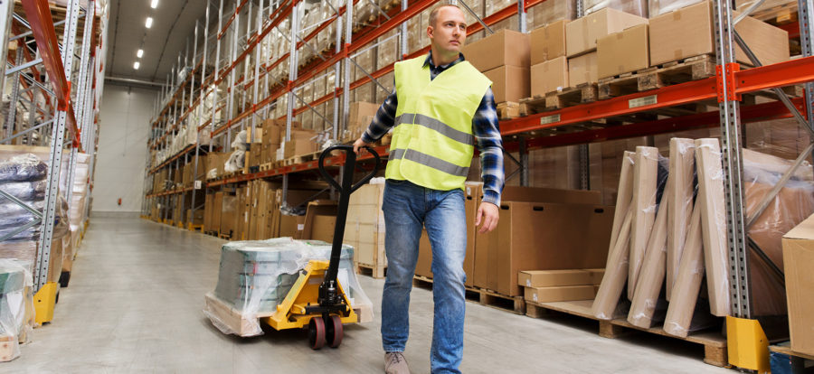 Man pulling cart in warehouse