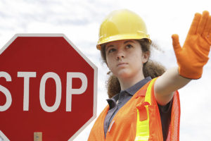 Female flagger holding stop sign