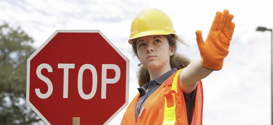 Female flagger holding stop sign