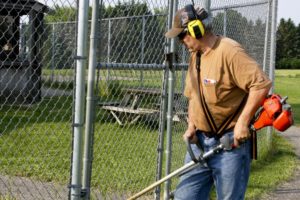 Landscaper cutting grass heat safety