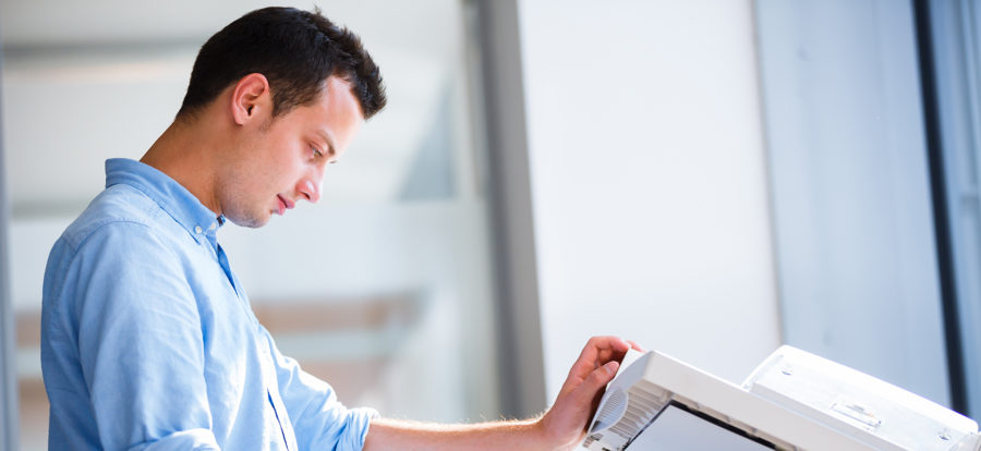Male administrative assistant making copies