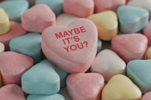 Candy heart reading "Maybe it's you?" representing hiring heartbreaks