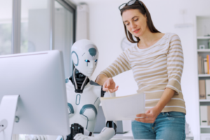 Woman talking to robot symbolizing administrative staff interacting in an AI-enhanced workplace